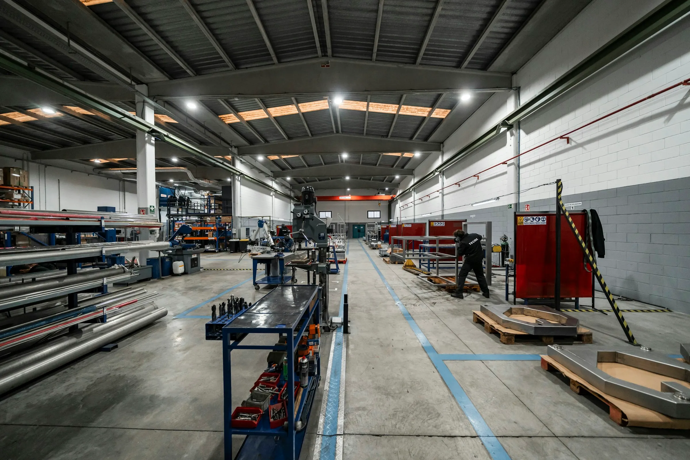 Industrial workshop interior with technician working at a fabrication station