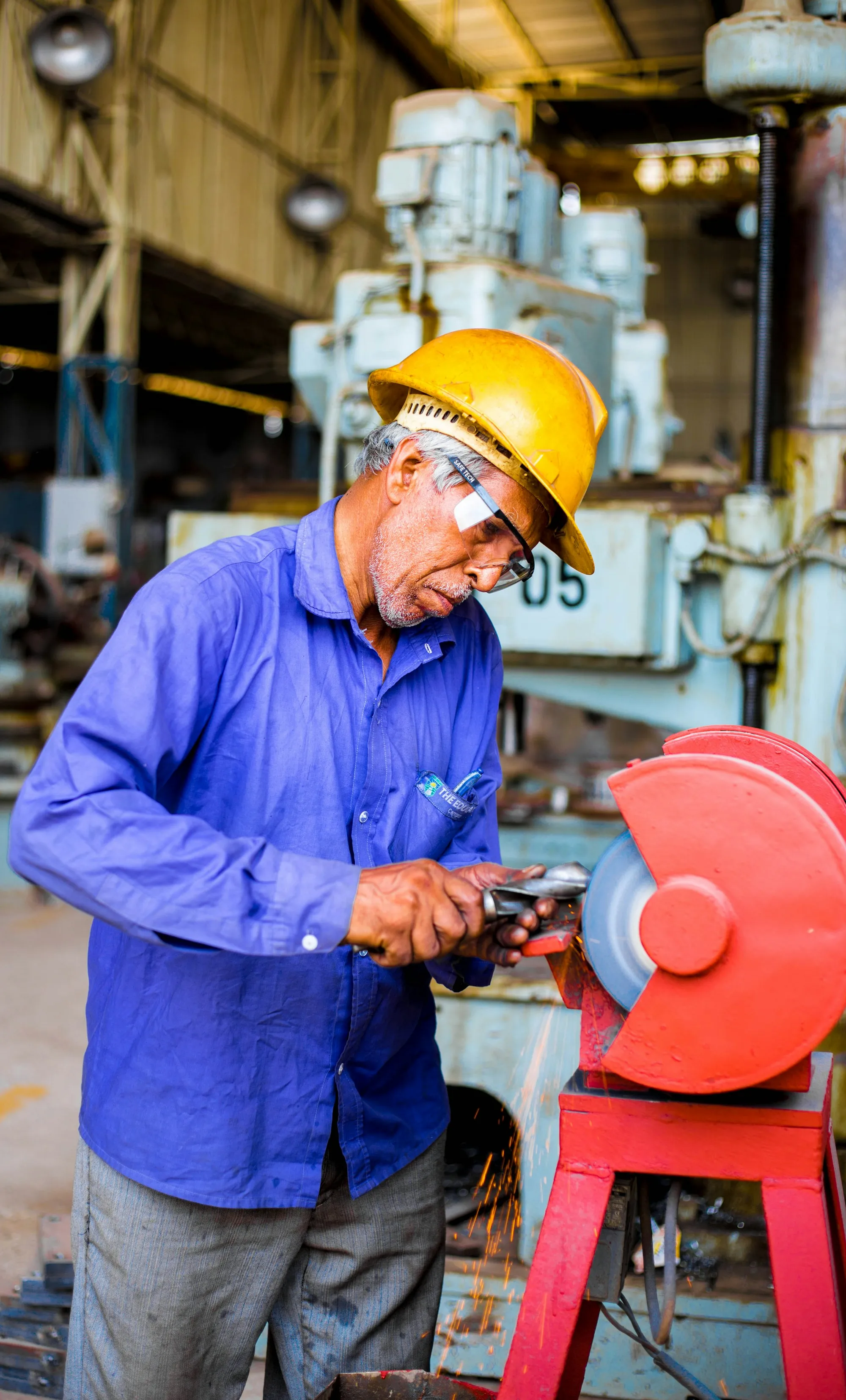 Industrial technician working hands-on with manufacturing equipment