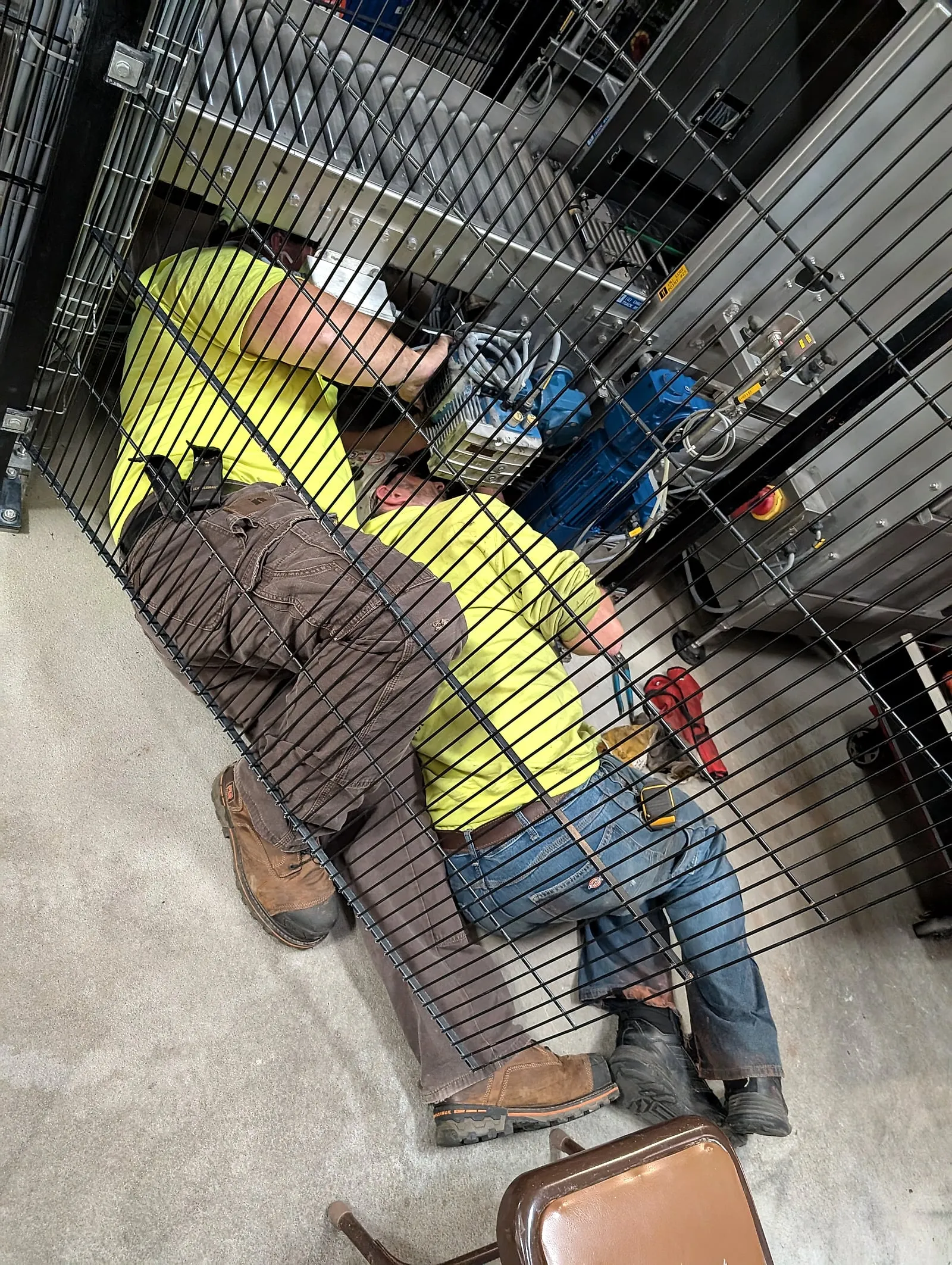 Matthew Kuss working hands-on inside an industrial equipment enclosure